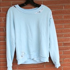 Distressed style sweatshirt with lace detailing.